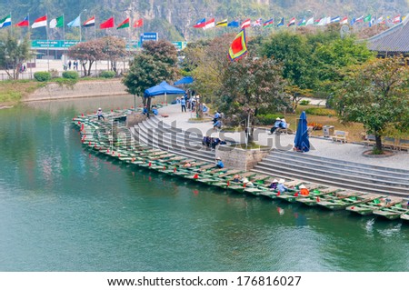 NINHBINH, VIETNAM, JANUARY 4: Unidentified boat owners wait for tourists visit Trang An grottoes on January 4, 2014 in Ninhbinh, Vietnam. Trang An grottoes are famous place in Ninhbinh province
