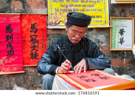 HANOI, VIETNAM, JANUARY 28: Old master is writing ancient letter for everyone in lunar new year on January 28, 2014 in Hanoi, Vietnam. This is a tradition of vietnamese people in lunar new year