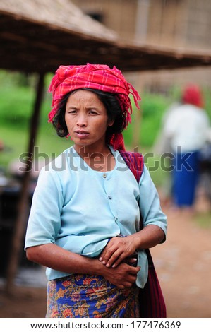 INLE LAKE, MYANMAR, SEPTEMBER 5: An unidentified Burmese woman with thanaka on her face on September 5, 2013 in Inle Lake, Myanmar. Thanaka is a yellowish-white cosmetic paste made from ground bark.