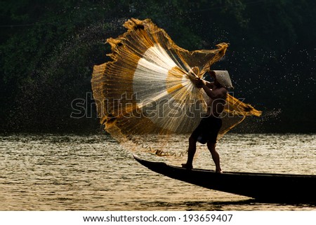 HUE, VIETNAM, MAY 2: An unidentified fishing man is throwing fishing net on May 2, 2014 in Hue, Vietnam. Hue, a UNESCO World Heritage site.