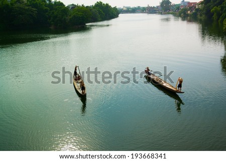 HUE, VIETNAM, MAY 2: Fishing men on boats on Perfume river on May 2, 2014 in Hue, Vietnam. Hue, a UNESCO World Heritage site.