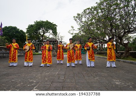 HUE, VIETNAM, MAY 4: Traditional music band perform in Forbidden city on May, 4, 2014 in Hue, Vietnam. Carriage is a transportation for tourist in Hue Forbidden city