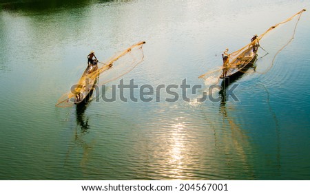 HUE, VIETNAM, MAY 2: An unidentified group of fisherman are throwing fishing net on May 2, 2014 in Hue, Vietnam. Hue, a UNESCO World Heritage site.
