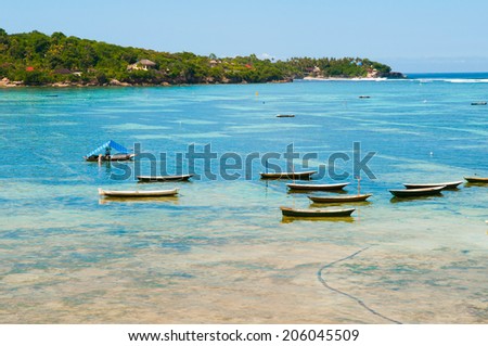 LEMBONGAN, INDONESIA, MAY 12: People in a boat in Lembongan island on May 12, 2014 in Lembongan, Indonesia. This is traditional boats in a village near beach in Lembongan island