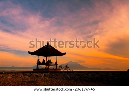 BALI, INDONESIA, APRIL 11: People on Nusa beach in sunrise on APRIL 11, 2013 in Bali, Indonesia. Nusa beach is one of the most famous beach in Bali island