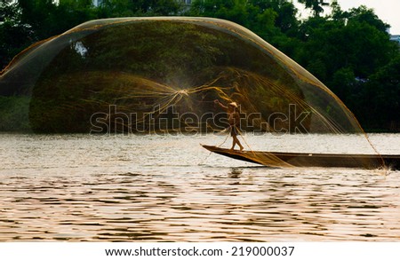 HUE, VIETNAM, MAY 2: An unidentified fishing man is throwing fishing net on May 2, 2014 in Hue, Vietnam. Hue, a UNESCO World Heritage site