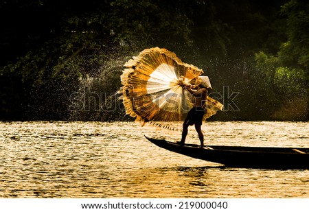 HUE, VIETNAM, MAY 2: An unidentified fishing man is throwing fishing net on May 2, 2014 in Hue, Vietnam. Hue, a UNESCO World Heritage site