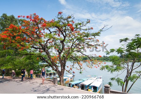 HUE, VIETNAM, MAY 2: Tourists are near Thien Mu pagoda and Perfume river on May 2, 2014 in Hue, Vietnam. Hue, a UNESCO World Heritage site.