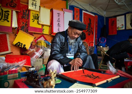 HANOI, VIETNAM, FEB 22: Old master is writing ancient letter for everyone in lunar new year on February 22, 2015 in Hanoi, Vietnam. This is a tradition of vietnamese people in lunar new year