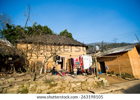 LAOCAI, VIETNAM, DEC 15: Hani ethnic minority people near their traditional house on December 15, 2014 in Laocai, Vietnam. The Hani people are an ethnic group of Vietnam.