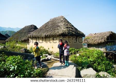 LAOCAI, VIETNAM, DEC 15: Hani ethnic minority people near their traditional house on December 15, 2014 in Laocai, Vietnam. The Hani people are an ethnic group of Vietnam.