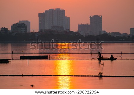 HANOI, VIETNAM, July 8, 2015. Boat in sunset in West Lake (Ho Tay) in Hanoi. West Lake is a biggest lake in Hanoi, Vietnam.