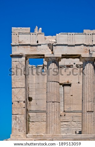 Fragment of the ruins of an ancient temple with columns Akropolyav Athens against the sky on a sunny summer day.