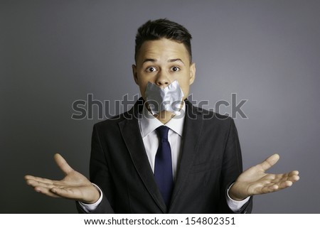 stock-photo-businessman-with-silver-tape-over-his-mouth-and-hands-up-conceptual-image-restriction-silence-154802351.jpg