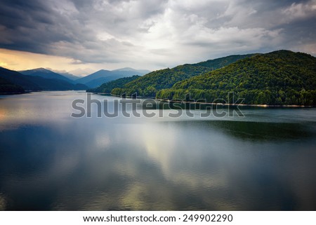 Vidraru Lake, Romania. Carpathian Mountains and secular woods.