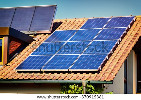Green Renewable Energy. Photovoltaic Panels on the Roof. A completely solar energy powered house.