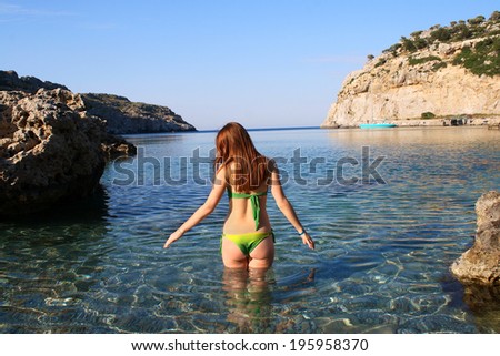 Attractive slim bikini model back enjoy beautiful sea bay with clear water  summer Greece