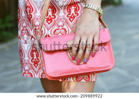 cute young woman in dress with little pink bag outdoor