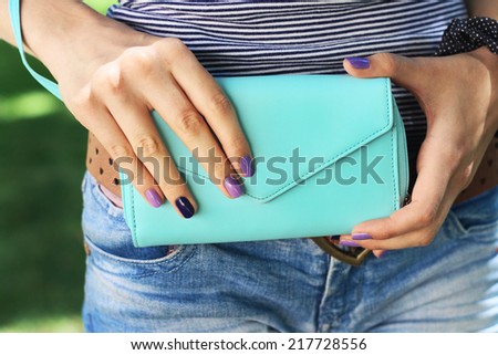 Beautiful female hands  sweet cute manicure hold blue  big purse