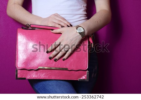 fashion young trendy girl hold big pink bag near purple wall