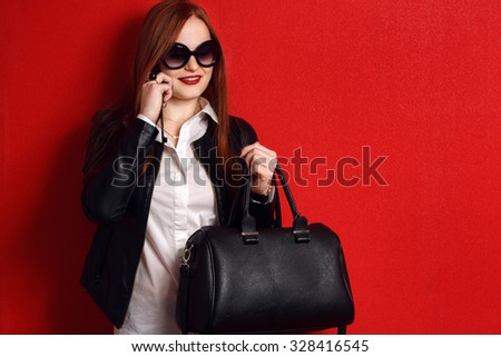 Fashion busy happy woman in trendy clothes . Wearing black  jacket, big handbag ,white shirt
