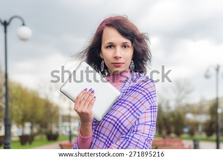 Young woman with Tablet reading from ebook