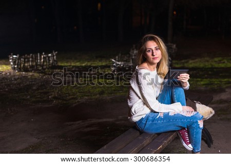 Young woman sitting with Tablet and reading from ebook