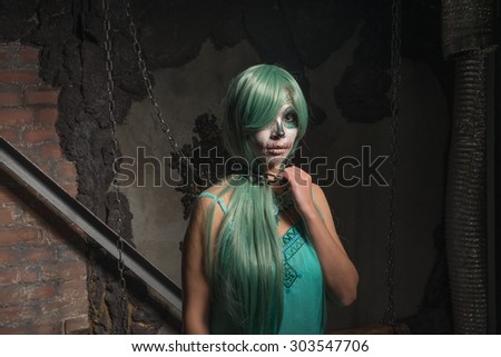 Halloween portrait of young woman with sugar skull makeup
