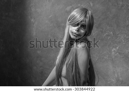 Black and white. Halloween portrait of young woman with sugar skull makeup