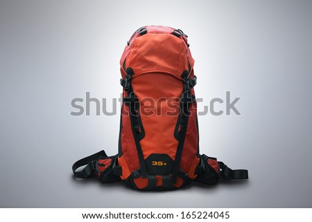 Red outdoor backpack isolated on studio background