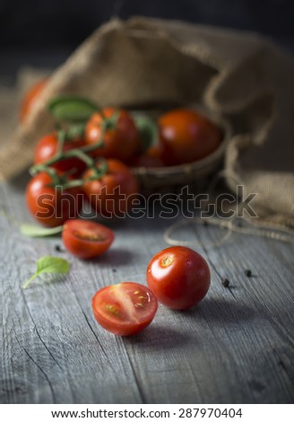 Cherry tomatos on wooden counter top. Rustic kitchen. Close-up.