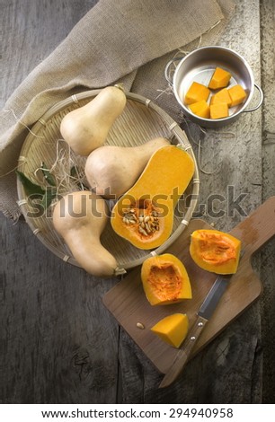 Butter squash cut open on wooden table top. Top view,