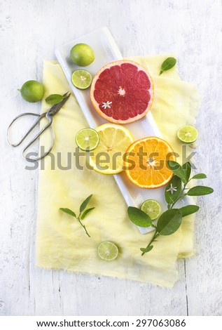 Sliced citrus fruits on white wooden table top. Top view. Food styling.
