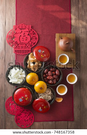 Conceptual flat lay Chinese New Year food and drink still life. Text appear in image: Prosperity, spring & good fortune.