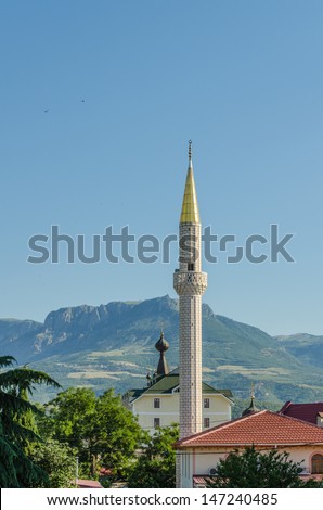 Church and a mosque in mountains