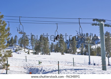 California Ski Resort Chair Lift with Rider going up the Mountain