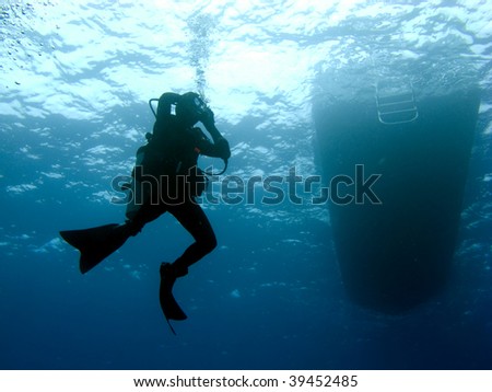 Scuba Diver Clearing Mask while Descending under the Boat