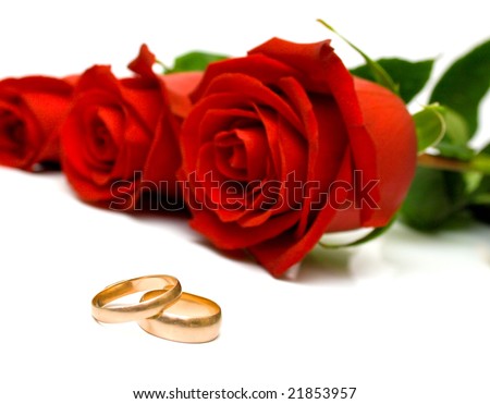 stock photo Wedding rings and red roses on white background Isolated