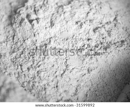 The white scattered powder similar to a flour. Abstract background. Shallow DOF