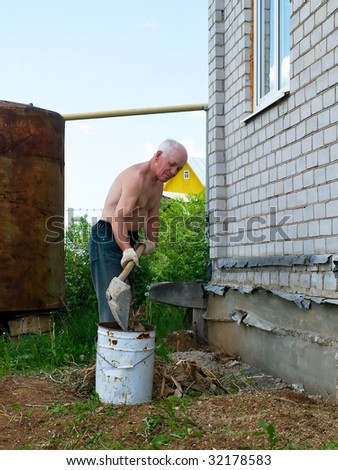 The elderly tired men is cleaned in a court yard of the house