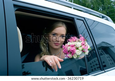 serenity bride with flower bouquet siting in the car. Shallow DOF, focus on flowers