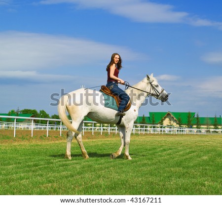 The serenity young girl astride a horse against blue sky