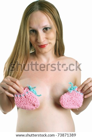 stock photo Portrait of naked pregnant women with bootees in hands on 
