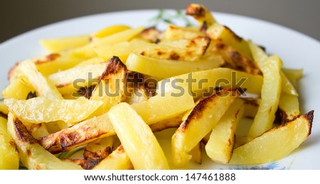 Prepared potatoes on white plate. Shallow DOF