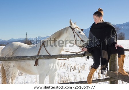 Young Woman With White Horse In Winter