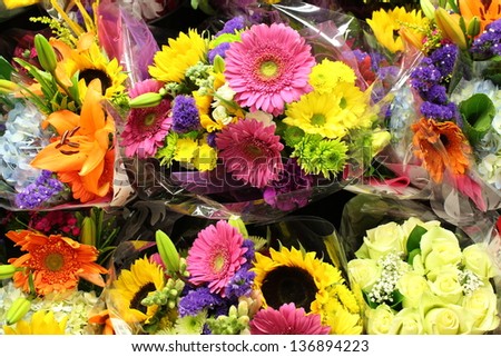 Arrangement of fresh seasonal flowers with colorful petals grown in gardens and sold at local farmer\'s market.