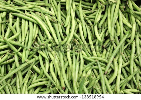 Fresh crisp green beans grown locally in a farmer\'s vegetable garden and displayed for sale at a neighborhood market in town.