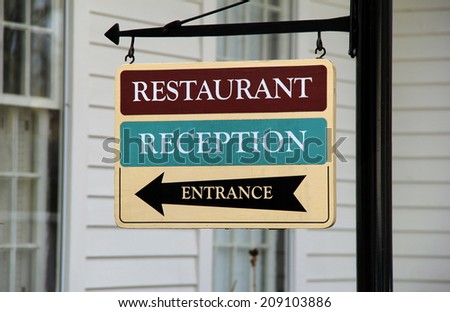 Bright and colorful sign that directs people to the restaurant,reception area and front entrance of the establishment.