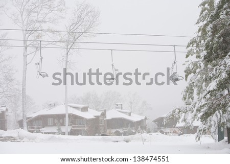 Mountain villas and a ski chairlift during a snow storm, Stowe, Vermont, USA