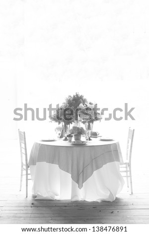 Black and White Hi-key image of a fine dinner table for two.